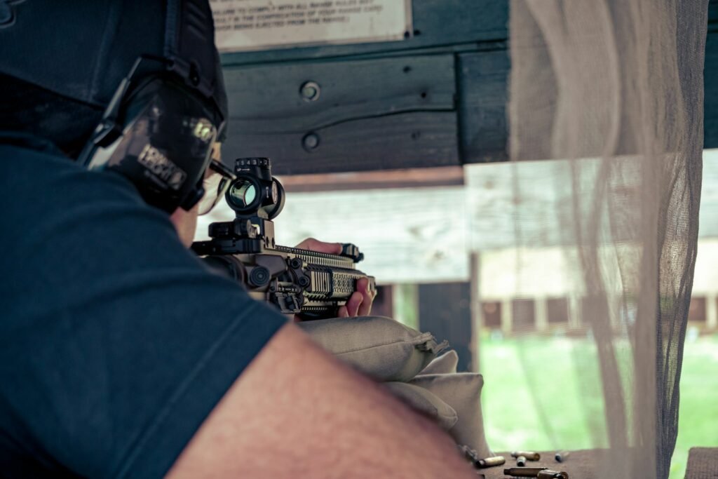 Member aiming a handgun down range during after-hours access at Topflight