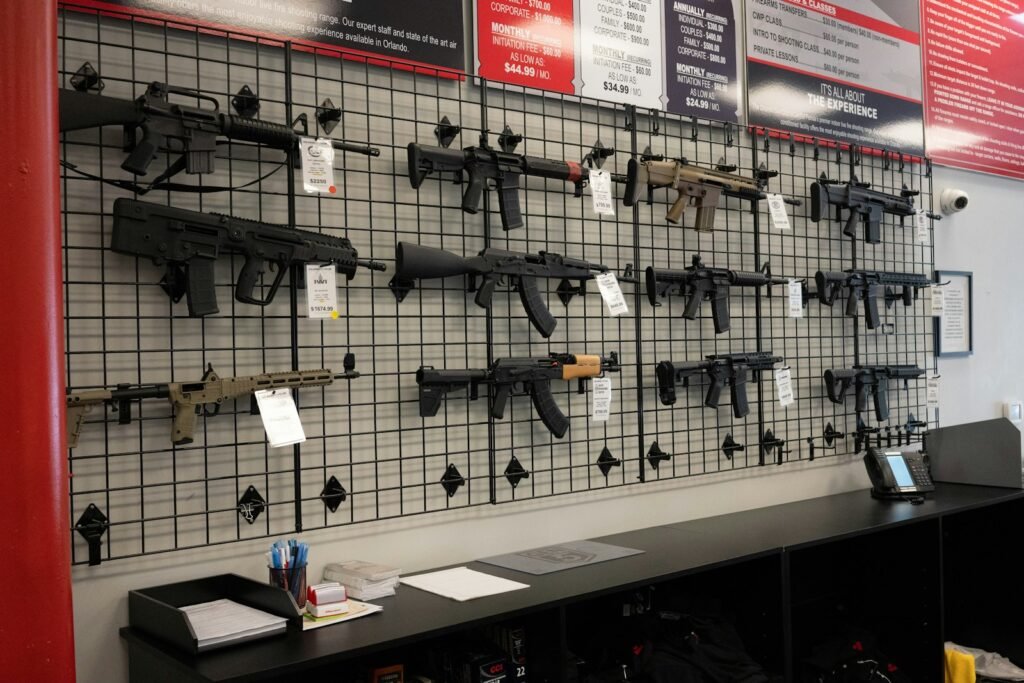 Rifles and handguns displayed on the wall of the Topflight firearms showroom in Dayton